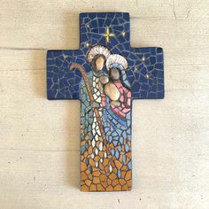 a cross made out of mosaic tiles with an image of the crucifix