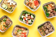 six takeout containers filled with different types of food on a yellow background, top view