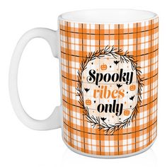 an orange and white coffee mug with the words spooky hugs only on it