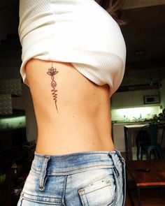 a woman with a tattoo on her lower back