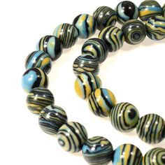 a necklace with black, yellow and white beads