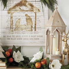 a christmas mantle with candles and ornaments on it