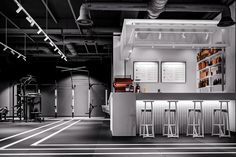 the inside of a gym with rows of machines and equipment in black and white colors