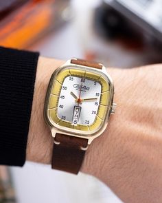 The Slava Tank watch stands as a remarkable testament to the innovative design and craftsmanship of the 1980s. Upon its debut, it immediately captured the attention and admiration of watch enthusiasts, not just for its timekeeping precision but also for its distinctive case shape - a feature that gave it its nickname.  Its structure, a harmonious blend of straight lines and curved edges, mirrors the robust yet elegant silhouette of a tank, thus earning its namesake. However, its unique appearance, reminiscent of the vintage refrigerators from the 1960s, affectionately earned it another moniker among collectors: the "Slava Fridge."  Crafted with meticulous attention to detail, the Slava is powered by the manual winding movement Cal.2628. This movement is celebrated for its reliability and i Retro Watches With Tachymeter As Gift, Retro Watch Accessories With Rectangular Analog Dial, Retro Watch Accessories With Analog Display And Rectangular Dial, Rare Watches, Vertical Calendar, Vintage Refrigerator, Tank Art, Watch Gift Box, Tank Watch