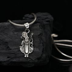 Metal-925 sterling silver. Item type-Pendant Weight-2.320 grams. Height-3.2 centimetre. Width-1.3 centimetres. Stamped-925. Finish-Oxidized. Chain details: chain width-1.5mm(if buy) Weight-12.500 to 18.500 grams(weight varies as per length) Chain type-screw chain. Sterling Silver Amulet Necklaces For Puja, Sterling Silver Amulet Necklace For Puja, Sterling Silver Necklaces With Oxidized Finish For Puja, Sterling Silver Hallmarked Necklaces For Rituals, Silver Amulet Necklaces For Puja, Symbolic Silver Jewelry For Puja, Symbolic Sterling Silver Jewelry For Puja, Sterling Silver Engraved Jewelry For Puja, Engraved Sterling Silver Jewelry For Puja