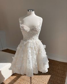 a white dress on a mannequin in a room