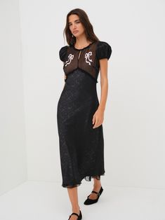 Embroidered with darling bow appliqus, the Catalina black midi dress is crafted is a floral jacquard with a contrast chiffon at the bust. Featuring puff sleeves and a flattering, body-skimming fitthis black slip dress is the perfect piece for a sultry winter party. Sultry Winter, Slip Dress Black, Black Slip Dress, Midi Slip Dress, Winter Party, Floral Jacquard, Wedding Lingerie, Black Midi, Black Slip Ons