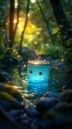 a blue candle with eyes in the water surrounded by rocks and trees at night time