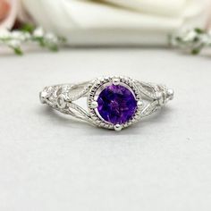 This beautiful ring is made from genuine 925 sterling silver with rhodium plating. Ring details- -The Main stone is a round cut 6mm Natural Amethyst -Side stones are Round Clear 1mm simulated diamonds -Ring is casted in solid 925 sterling silver with rhodium plating (yellow gold and rose gold plated also available, please check the drop down menu for more options) -The Total face height of the ring measures 10mms and the band width measures 2mms -Each ring is handmade and made to order, so pleas Classic Amethyst Birthstone Ring In White Gold, Classic Amethyst Birthstone Promise Ring, Classic Amethyst Promise Ring With Center Stone, Classic Amethyst Crystal Ring For Anniversary, Amethyst Birthstone Ring With Center Stone For Promise, Elegant White Gold Amethyst Promise Ring, Classic Purple Jewelry For Promise, Classic Amethyst Cubic Zirconia Promise Ring, Elegant Sterling Silver Amethyst Birthstone Ring