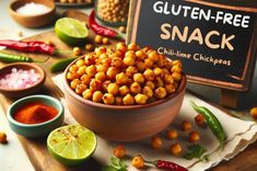 a bowl filled with chickpeas sitting on top of a wooden table next to other bowls