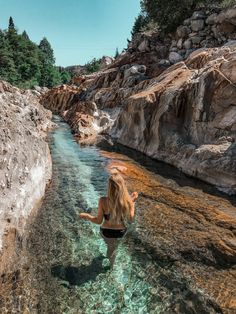 a woman is wading through the clear water