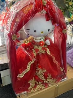 a hello kitty doll in a red dress