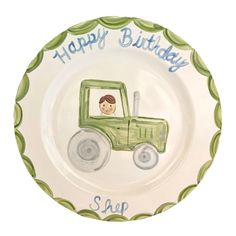 a plate with a green tractor on it and happy birthday message in blue lettering that reads, soap