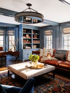 a living room filled with furniture and bookshelves