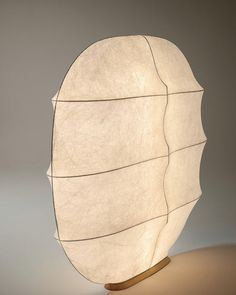 a light that is sitting on top of a wooden stand in the shape of a leaf