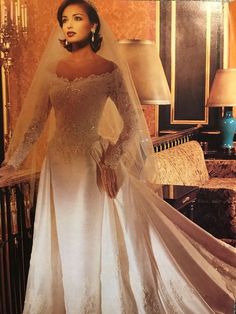 a woman in a wedding dress posing for the camera