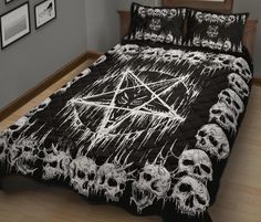 a bed covered in black and white skulls with an inverted pentagramm on it