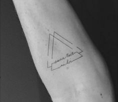 a small triangle tattoo on the arm