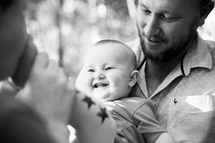 a man holding a baby in his arms