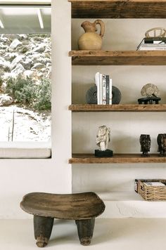 a wooden bench sitting in front of shelves filled with books