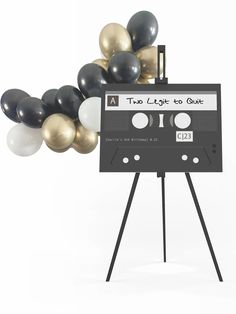 an old school cassette with balloons in the shape of a boombox on a tripod