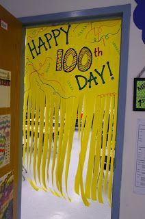 a classroom door decorated with yellow streamers and the words happy 100th day