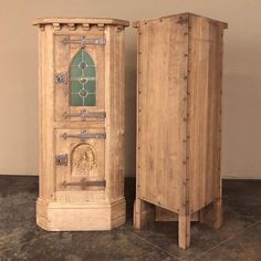 two wooden cupboards sitting next to each other on the floor in front of a wall