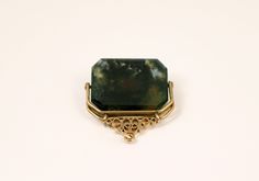 Victorian Era Spinner Fob features a central semi transparent moss agate stone. When held up to the light lovely swirl of rich hues of green can be seen. Very uplifting and soothing. Its framed in 14k gold and can be worn as a pendant. Moss agate as always been seen as a lucky amulet. Unique Green Gemstones For Formal Occasions, Formal Large Green Gemstone, Elegant Agate Pendant Gemstone, Elegant Moss Agate Cabochon Jewelry, Elegant Rectangular Agate Jewelry, Elegant Gemstones With Natural Inclusions For Gift, Grapevine Tx, Moss Agate Stone, Navajo Turquoise