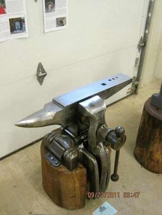 a metal work bench sitting on top of a piece of wood