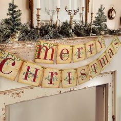 a merry christmas banner hanging from the mantle