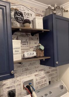 a washer and dryer in a room with brick wall behind the washer