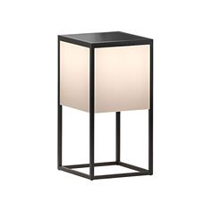 a black table lamp with a white shade on it's side and a square base