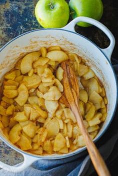 apples and cinnamon in a pot on a table