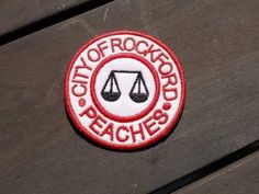 a red and white patch with the words city of rockwood beaches in front of it