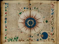 an open book with decorative designs and writing on the pages, including a sun symbol