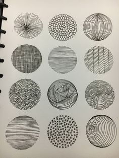 an open notebook with some drawings on it, including circles and lines in black ink