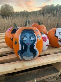 three pumpkins with faces painted on them