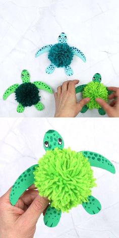 someone is holding a green pom - pom turtle and making it look like they are