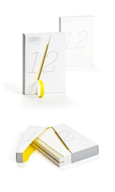 two white and yellow books with numbers on the front, one is folded in half