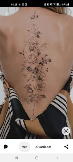 the back of a woman's body with flowers on it