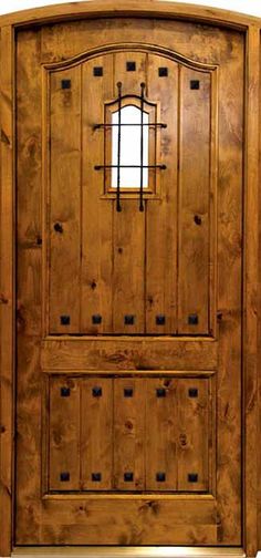 a wooden door with an arched window on the top and bottom panel, made out of wood