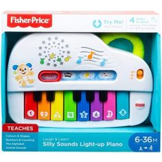 the fisher - price musical toy is white and has multicolored piano keys in it