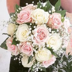 a bridal bouquet with pink and white roses