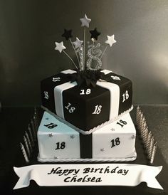 a black and white birthday cake with stars on top