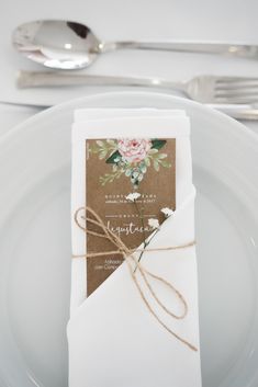 a place setting with white plates and silverware