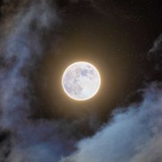 an image of the moon in the sky with clouds and stars around it, as seen from earth