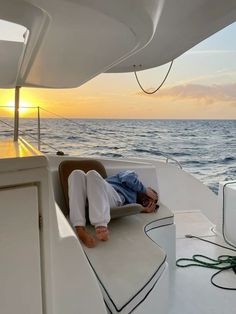 a man laying on the back of a boat