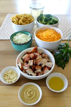 bowls filled with food sitting on top of a wooden table