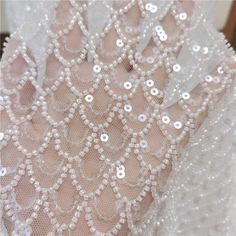 the back of a white dress with sequins on it