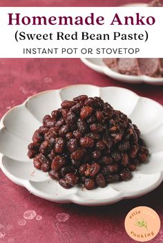 a white bowl filled with sweet red bean paste on top of a pink table cloth